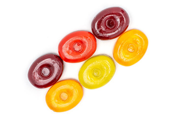 Group of six whole colourful hard candy in line flatlay isolated on white background