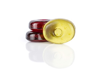 Group of three whole colourful hard candy two wine one yellow isolated on white background