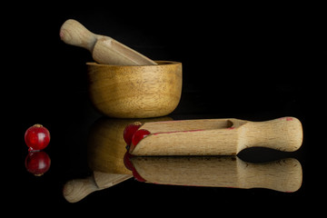 Group of two whole fresh red currant with wooden scoop in bamboo bowl isolated on black glass