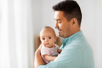family, parenthood and fatherhood concept - middle aged father with little baby daughter at home