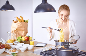 Young Woman Cooking in the kitchen. Healthy Food