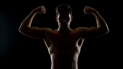 Strong masculine man showing biceps muscles, bodybuilding challenge, sports