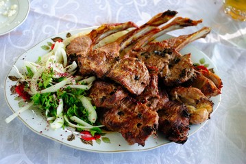 Different types of Azeri kababs served with onions and sumac in Agsu region of Azerbaijan
