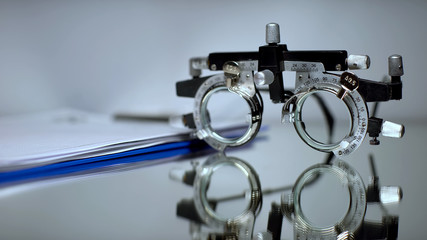 Prescription folder and optical trial frame for vision checking lying on table