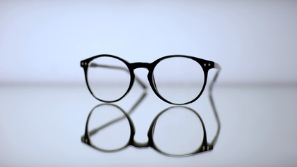 Stylish corrective eyeglasses lying on table, optometrist prescription, vision