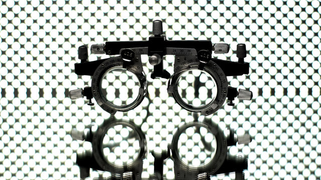 Phoropter for eyesight examination lying on glass surface, optical equipment