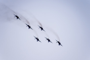 Air show in the sky above the Krasnodar airport flight school. Airshow in honor of Defender of the Fatherland. MiG-29 in the sky.