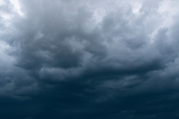 Obraz premium Dark thunder clouds on the blue sky. Abstract background with clouds on blue sky.