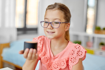 children, education and technology concept - student girl using smart speaker at home