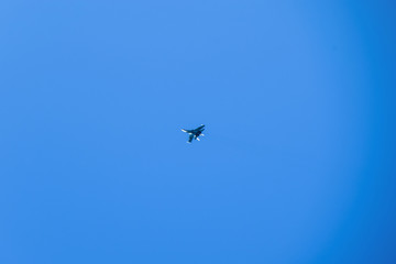 The fighter in the blue sky. Flying an airplane