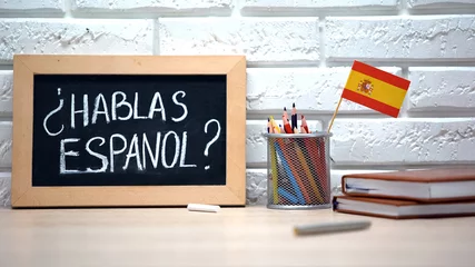 Foto op Canvas Do you speak Spanish written on board, international flag in box, language © motortion