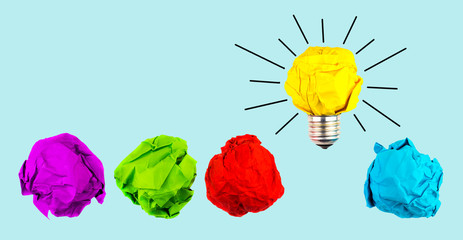 Great idea, standing out of the crowd concept. Crumpled paper as symbol of a light bulb, idea isolated on blue background