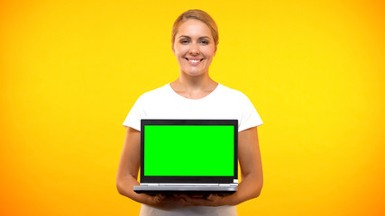 Smiling pretty lady holding laptop green screen, online presentation, freelance