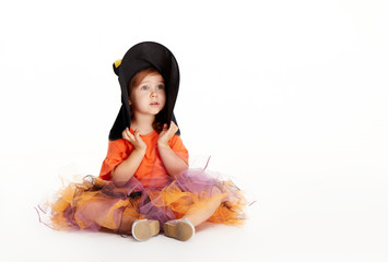 Happy Halloween party. Funny child girl in witch costume for Halloween on white isolated...