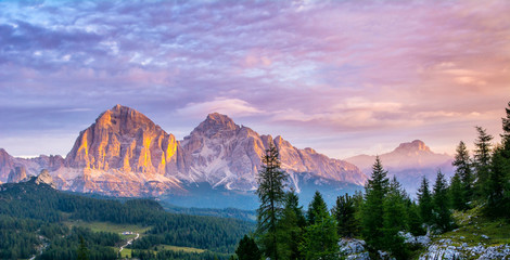 Panoramic view of famous Dolomites mountain peaks glowing in beautiful golden evening light at sunset in summer, South Tyrol, Italy. Artistic picture. Beauty of mountains world