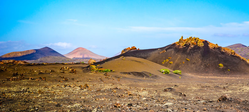 Amazing landscape of volcano craters in Timanfaya national park. Popular touristic attraction in Lanzarote island, Canary islans, Spain. Artistic picture. Beauty world.