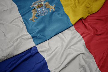 Fototapeta premium waving colorful flag of france and national flag of canary islands.