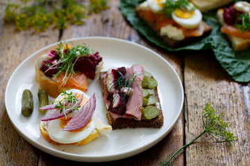 Selection of Scandinavian open sandwiches with beef, beetroot and egg