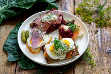 Selection of Scandinavian open sandwiches with beef, beetroot and egg