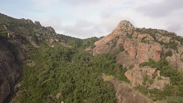 Drone panning around to reveal a beautiful vally and town in the distance in Frejus France