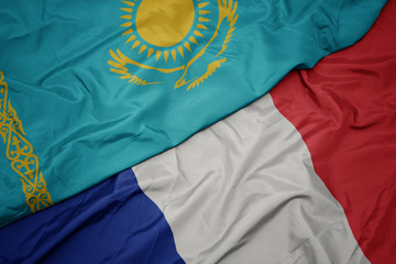 waving colorful flag of france and national flag of kazakhstan.