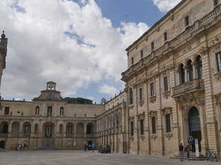Fototapeta na wymiar Lecce – Bishop's palace. This monumental palace has a baroque facade surmounted by a clock and it is situated in Piazza Duomo of Lecce.