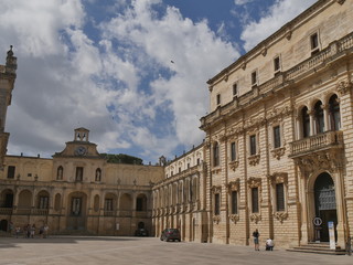 Fototapeta na wymiar Lecce – Bishop's palace. This monumental palace has a baroque facade surmounted by a clock and it is situated in Piazza Duomo of Lecce.