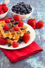 Two Classic Berry Waffles on a Rustic Blue Wood Table