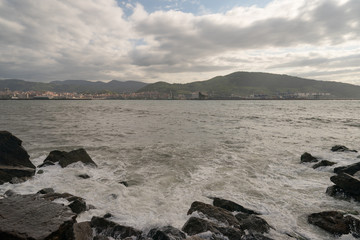 Fototapeta na wymiar Atlantic ocean, town on the shore of Biscay Bay in summer day in Basque country near Bilbao city. Natural background, suitable for banner, postcard, greeting card, poster. High resolution photography.