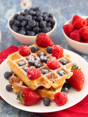 Two Classic Berry Waffles on a Rustic Blue Wood Table
