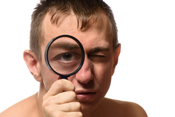 Fototapeta na wymiar Big open eye. A man holds a magnifier near his face. Search. White background