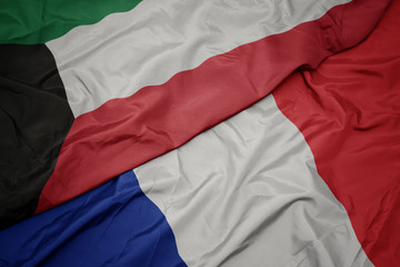 waving colorful flag of france and national flag of kuwait.