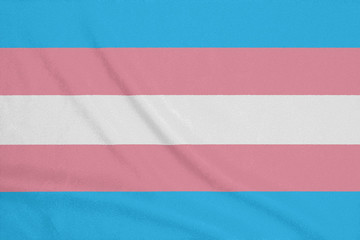 LGBT Transgender community flag on a textured fabric. Pride symbol