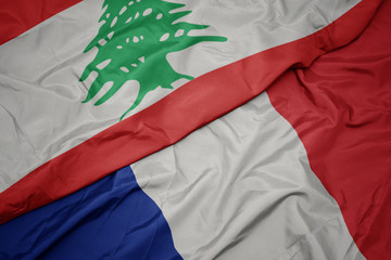 waving colorful flag of france and national flag of lebanon.