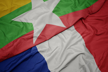 waving colorful flag of france and national flag of myanmar.