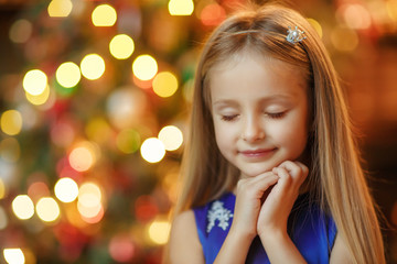 Little blonde girl in blue dress, new year