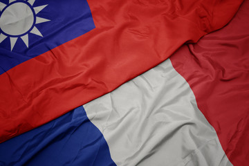 waving colorful flag of france and national flag of taiwan.