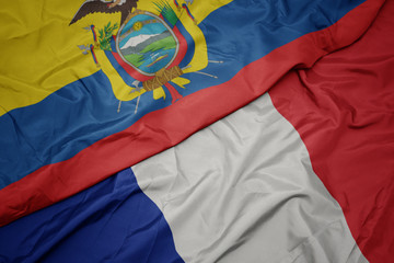 waving colorful flag of france and national flag of ecuador.