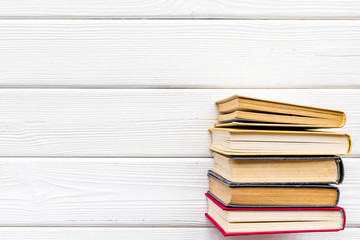 Books on library desk for reading and education on white wooden background top view mockup