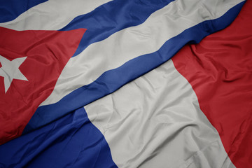 waving colorful flag of france and national flag of cuba