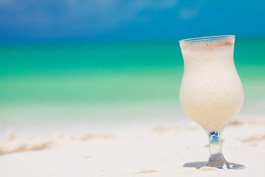 Pinacolada drink in cocktail glass on the beach