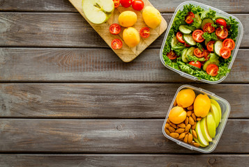 food container with salad on wooden background top view mock up