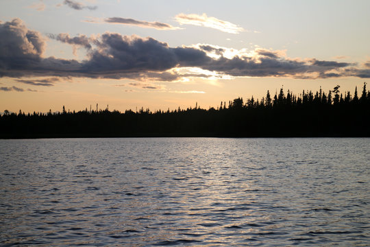 Sunset Over The Lake With Tree Silouhette