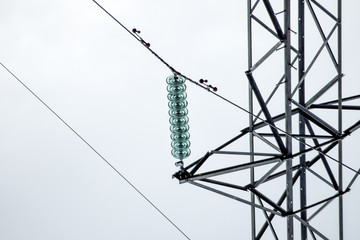 Glass prefabricated high voltage insulators on poles high-voltage power lines. Electrical industry