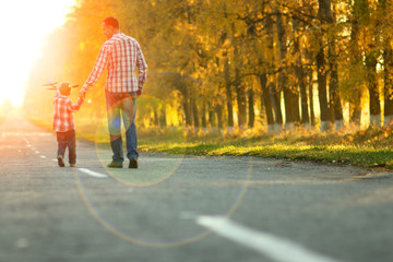 happy father and son go along the road