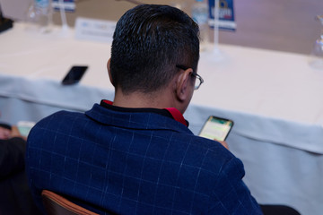 Businessman at business conference room with public giving presentations. Audience at the...
