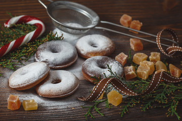 Homemade donuts with candy cane for the Christmas, New Year or any winter celebration on the vintage wooden background