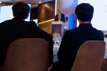 Businessman at business conference room with public giving presentations. Audience at the...