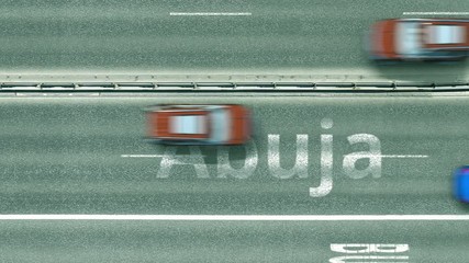 Aerial top-down view of the road. Cars reveal Abuja text. Travel to Nigeria conceptual clip
