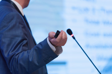 Businessman at business conference room with public giving presentations. Audience at the...